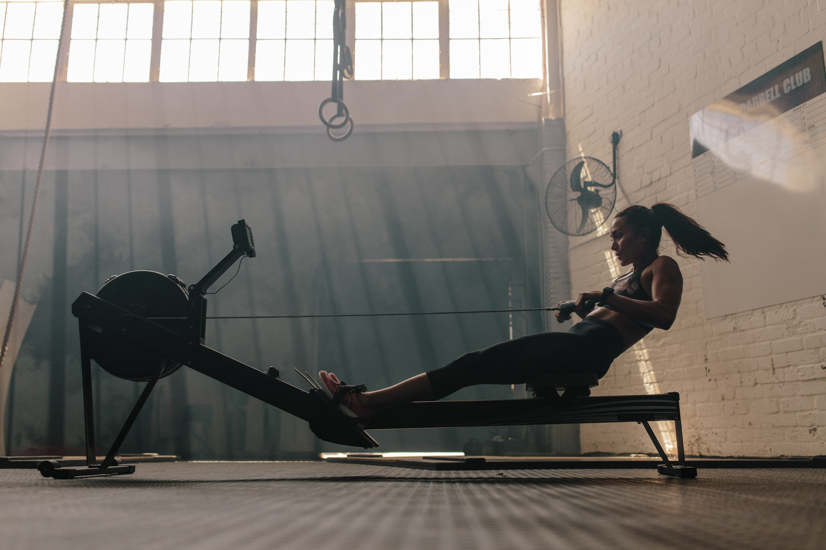 Woman Doing Cardio Workout on Rowing Machine